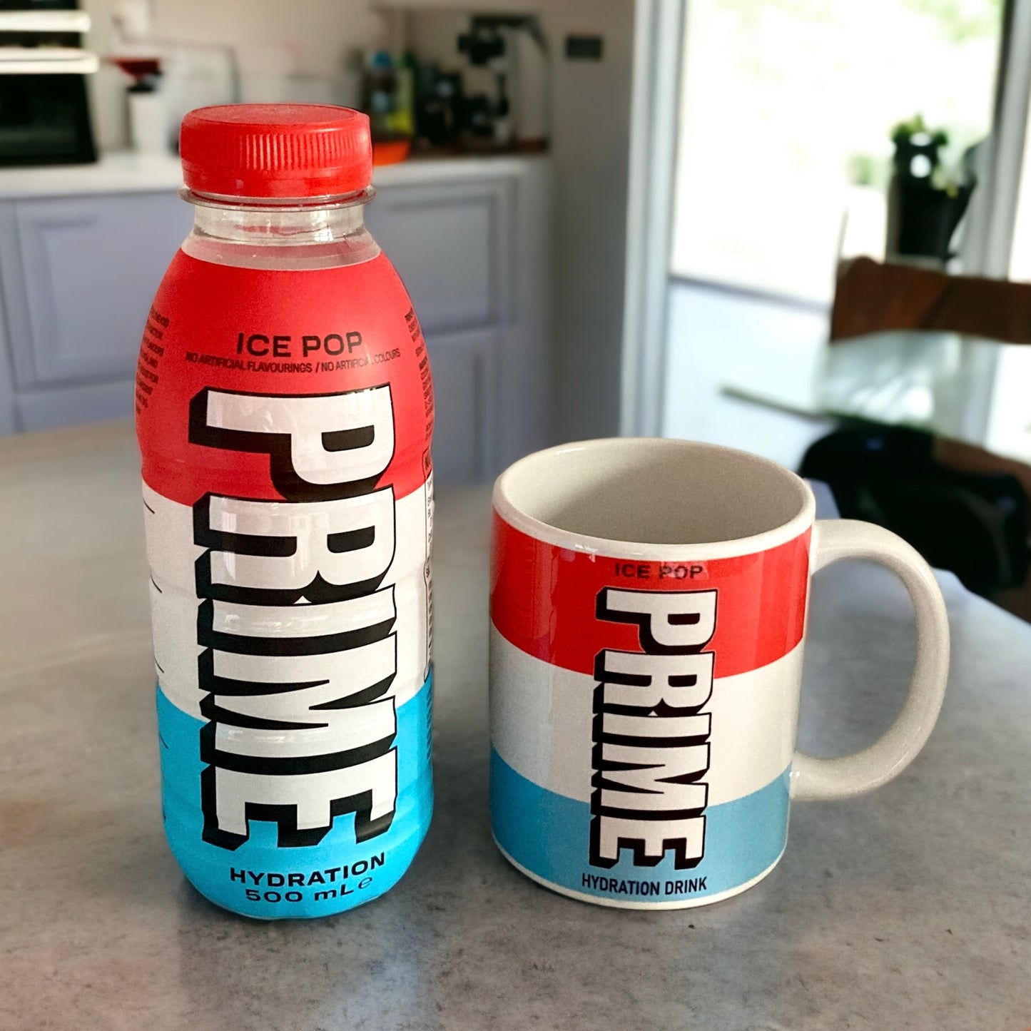 PRIME hydration drink bottle and mug on a kitchen counter