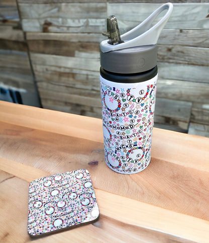 Patterned water bottle and coaster on a wooden surface with a wooden wall background