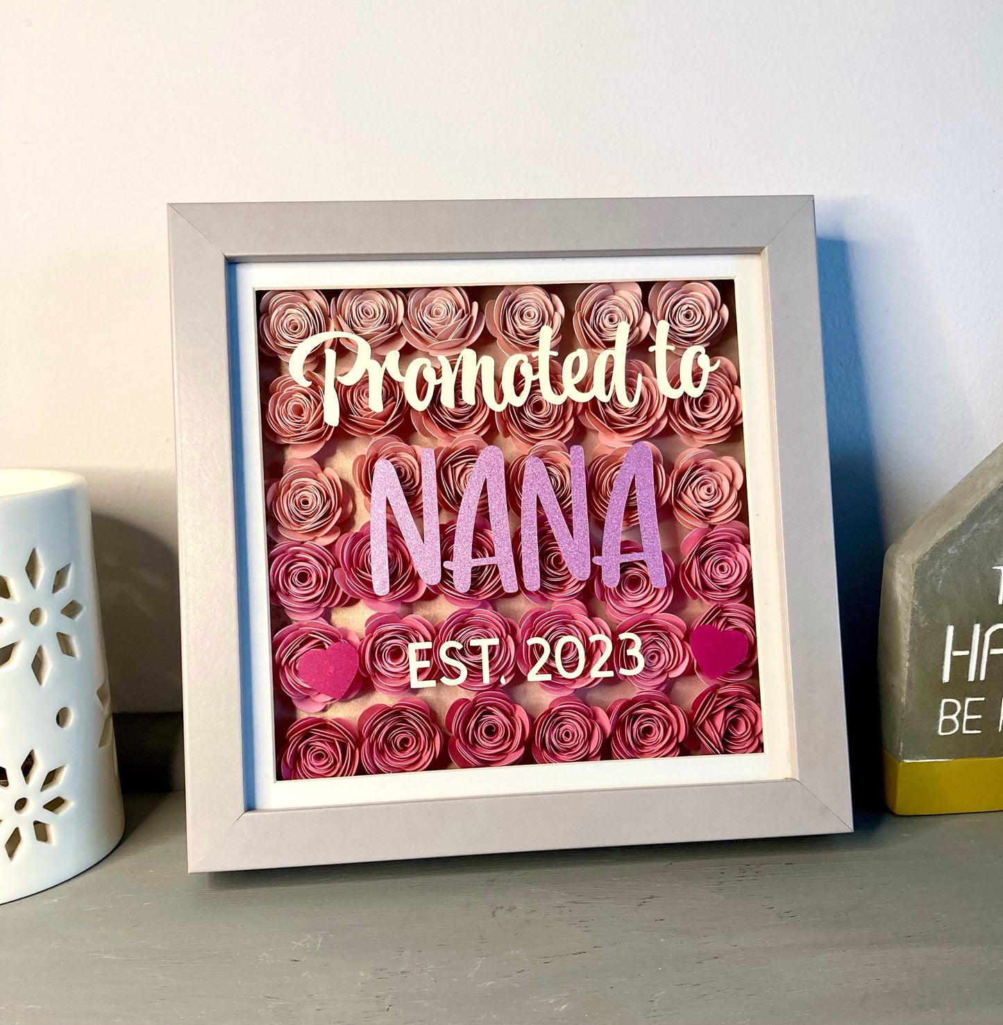 Paper flowers in shadow box with customisable message eg. baby announcement
