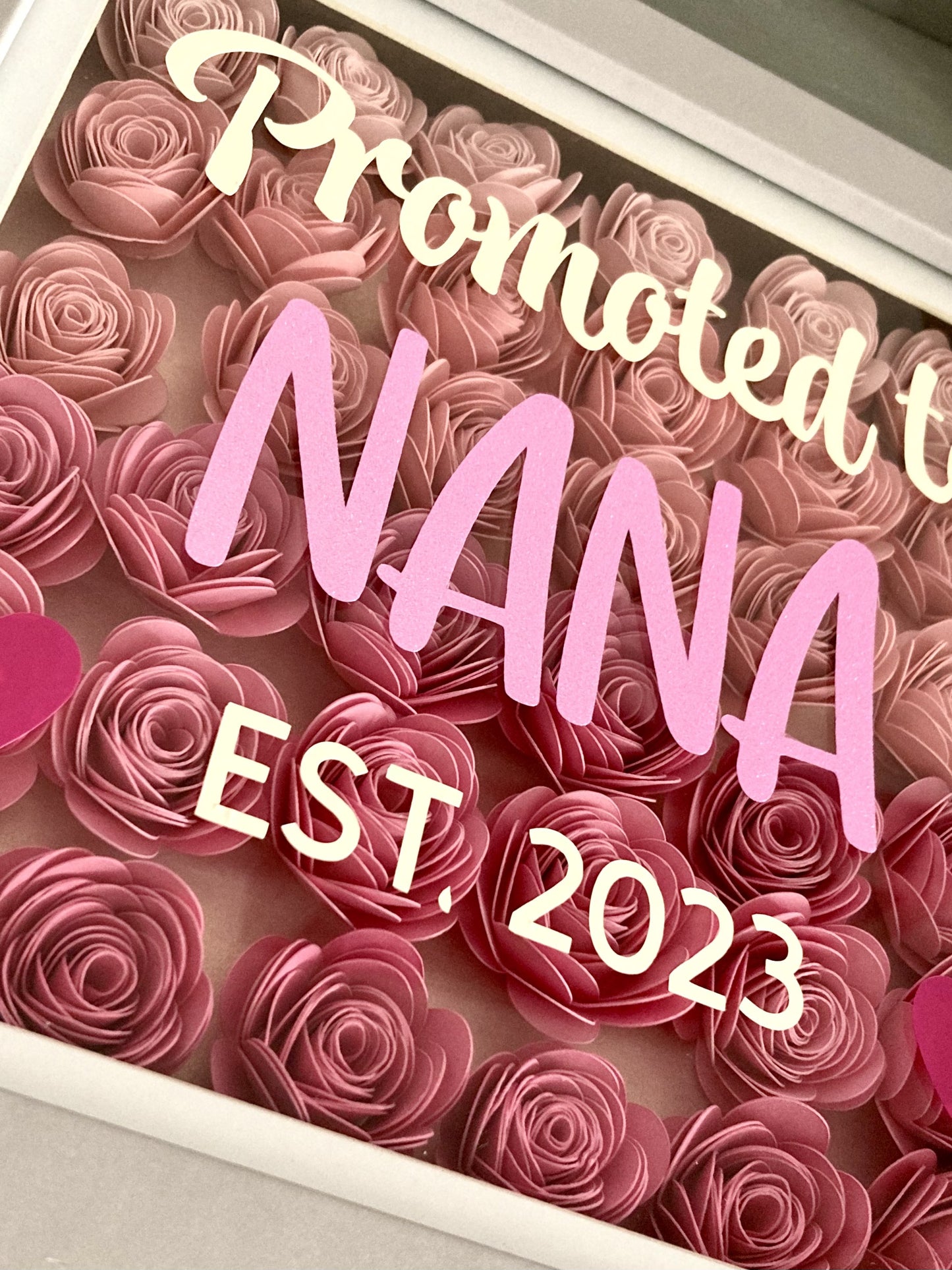Paper flowers in shadow box with customisable message eg. baby announcement